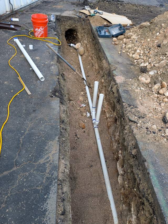 New PVC line with fittings in a trench